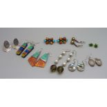 A collection of silver mounted earrings