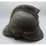 An early 20th Century fireman's helmet with silver embellishments, Birmingham 1926 hallmarks