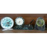 A Russian alarm clock, a granite ships wheel calendar and a marble based clock and pen stand