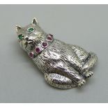 A silver cat brooch with ruby collar and emerald eyes