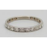 A white metal and diamond eternity ring, set with twenty diamonds, 3.2g, V