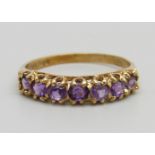 A 9ct gold and seven stone amethyst ring, 1.6g, N