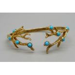 A silver gilt and turquoise bangle with hinged arm, marked Sundays Child