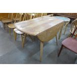 An Ercol Blonde elm and beech drop leaf table