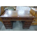 A mahogany and leather topped pedestal desk