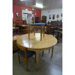 A Nathan teak extending dining table and four chairs