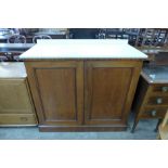 A Victorian walnut and marble topped two door cupboard