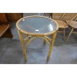 A circular bamboo and glass topped occasional table