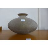 A large pebble shaped glass vase