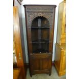 A carved Ipswich oak freestanding corner cabinet