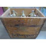A Schweppes soda stream box with six soda syphons