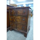 A small mahogany serpentine chest of drawers