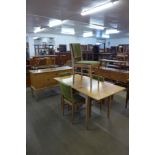 A Gordon Russell walnut six piece dining suite, comprising; extending dining table, four chairs