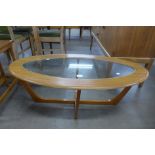 A teak effect oval glass topped coffee table