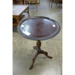 A mahogany tripod wine table