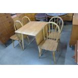 An Ercol Blonde elm and beech Windsor drop-leaf table and four chairs
