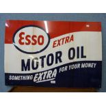 An Esso Extra Motor Oil advertising sign