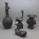 Four oriental bronzes; two vases, a model of a ceremonial elephant and babies in a cradle