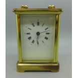 A brass and four glass sided carriage clock, with keys, (purchased from Pragnells of Stratford