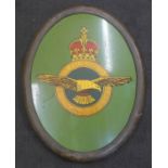 A bronze framed tin-plate plaque with the Royal Air Force insignia, 70cm