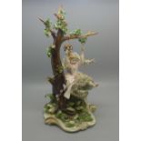 A Neapolitan figure of a boy pushing a girl on a swing, small chip to back of base, 29cm