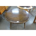 A Ercol Golden Dawn elm and beech circular coffee table