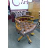 A mahogany and chestnut brown leather revolving Captains desk chair