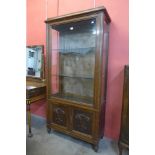A French carved oak display cabinet