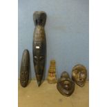 Three African carved wooden masks and two others