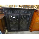 A Victorian carved oak wall hanging corner cabinet