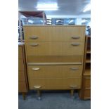 A teak chest of drawers