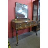 An Art Deco Egyptian Revival walnut and painted leather dressing table, manner of Carlo Bugatti