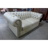 A cream leather Chesterfield settee