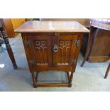 A small carved oak two door cupboard