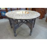 An Anglo-Indian carved hardwood and brass topped occasional table