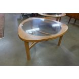 A Nathan teak and glass topped triangular coffee table