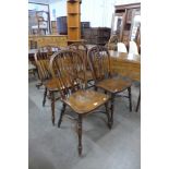 A set ot four elm and beech wheelback kitchen chairs