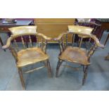 A pair of similar Victorian fruitwood and mahogany smokers bow chairs