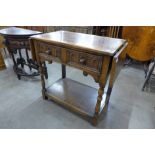 A 17th Century style carved Ipswich oak single drawer drop leaf side table