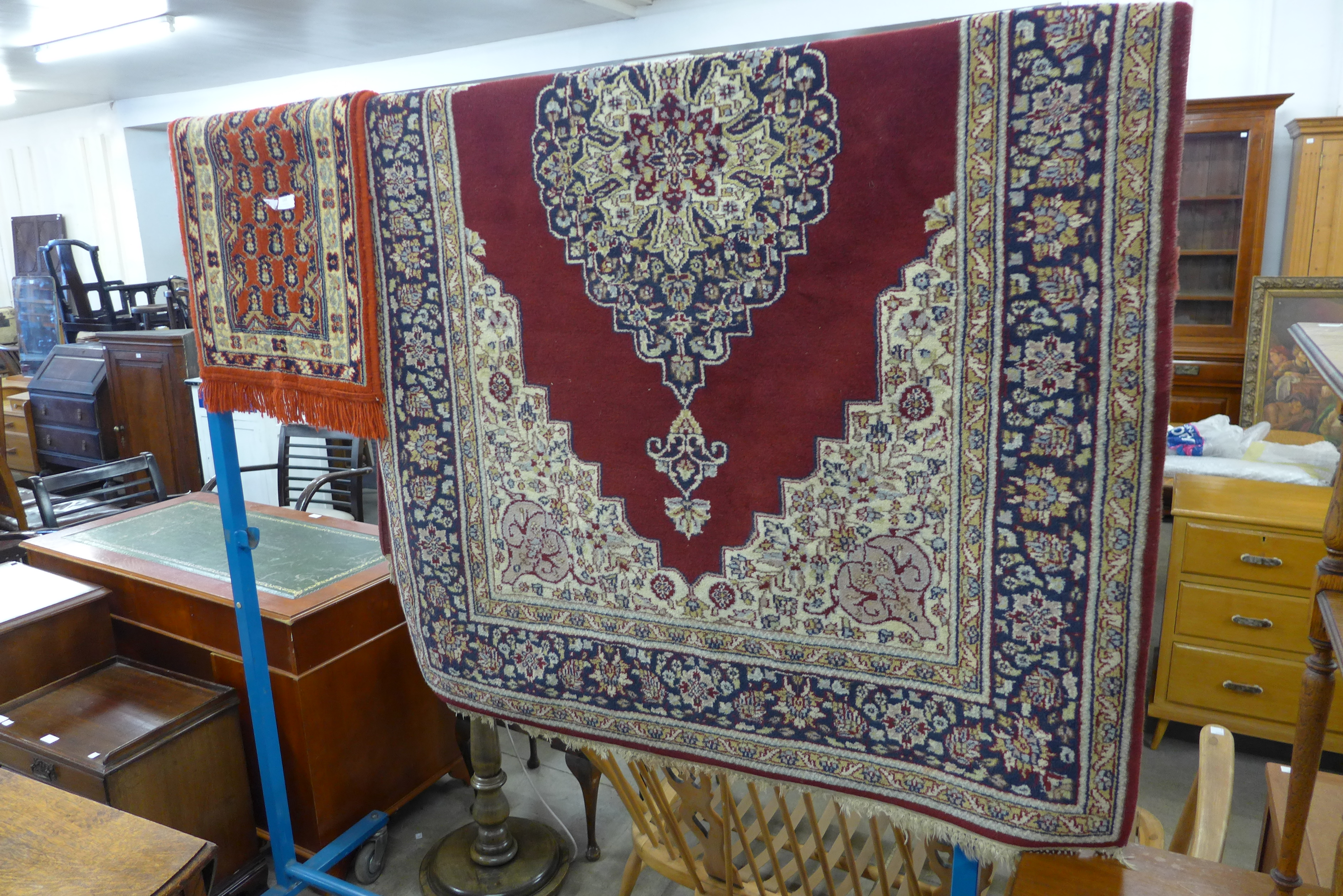 A burgundy ground rug and a prayer mat