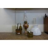 A copper oil lamp, assorted oil lamp chimneys, etc.