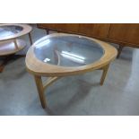 A Nathan teak and glass topped triangular coffee table