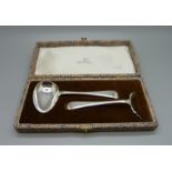 A silver spoon and pusher christening set, boxed, Walker & Hall, Sheffield 1955, 52g