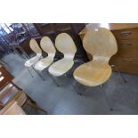 A set of four bent plywood and chrome stacking chairs