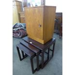 A teak bedside cabinet and a mahogany nest of tables