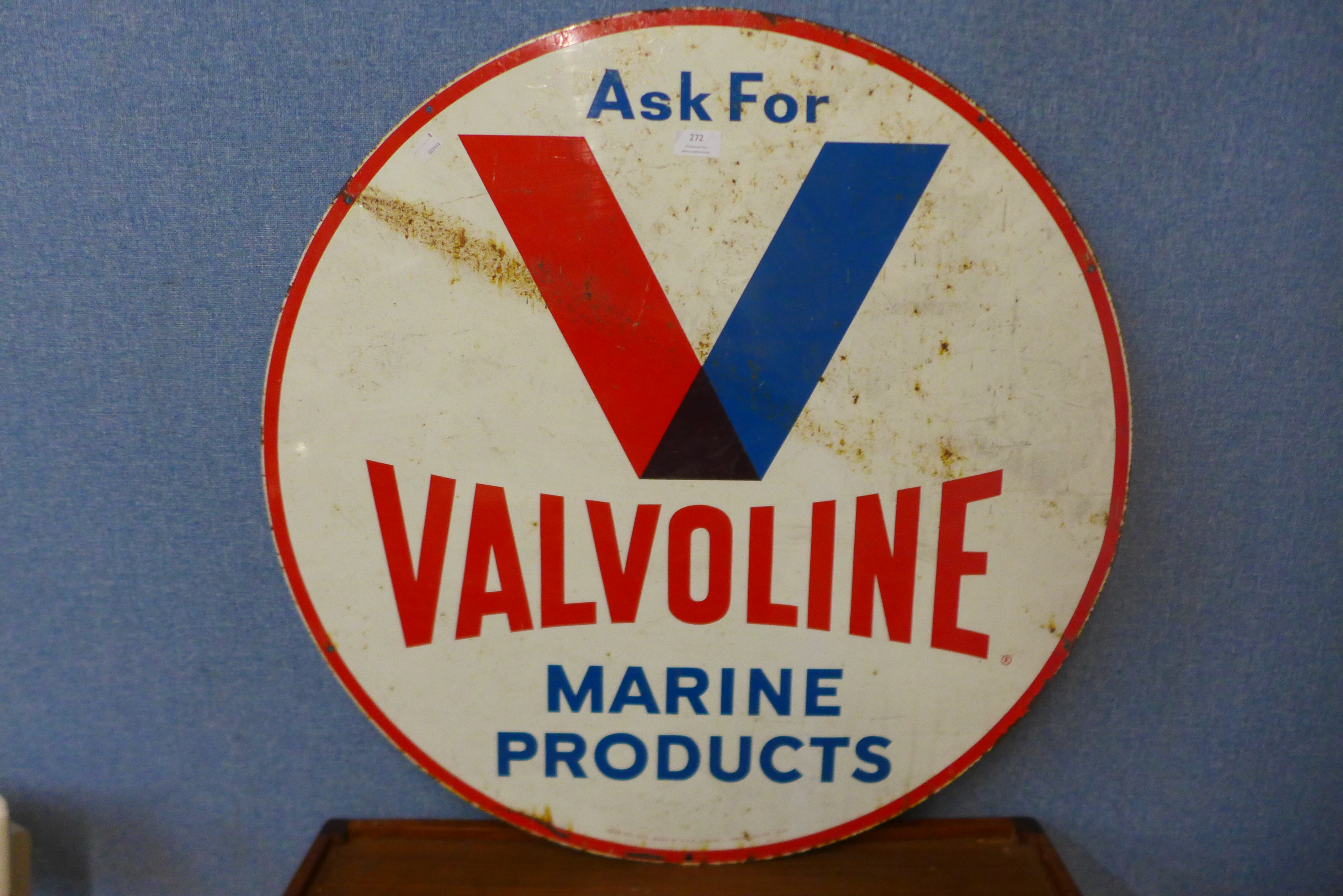 A metal double sided circular Valvoline Marine products advertising sign
