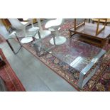 A chrome and glass coffee table with matching occasional table
