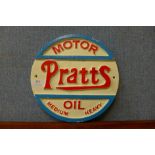 A reproduction cast iron Pratts Motor Oil advertising sign