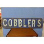 A painted wooden Cobblers sign