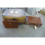 A tin steamer trunk, a leather case and a satchel